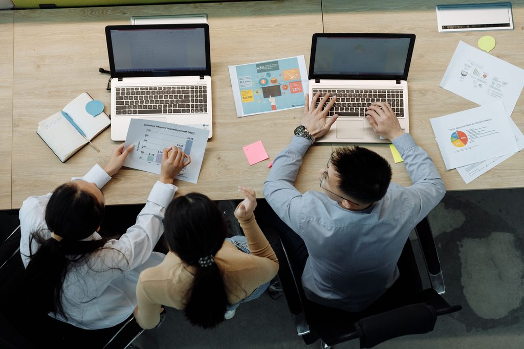Two people looking on laptops